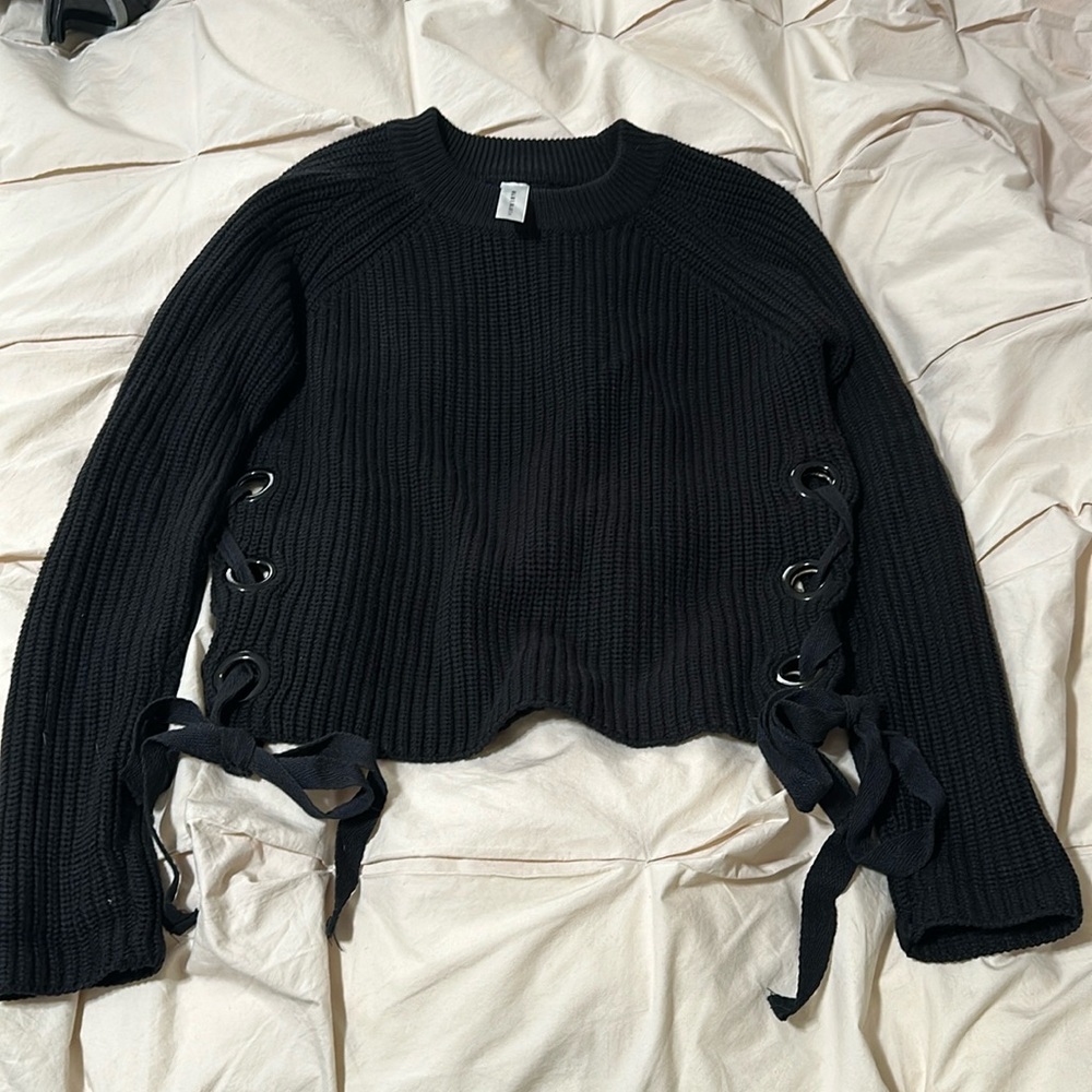 Lightly worn black knit sweater tied on the sides.